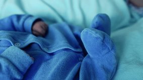 Newborn baby peacefully sleeping on a blue blanket, capturing the serenity and innocence of early days. Dressed in a soft blue outfit, the baby rests with closed eyes, surrounded by a calm atmosphere - Powered by Shutterstock - Get 15% off with code: PIKWIZARD15