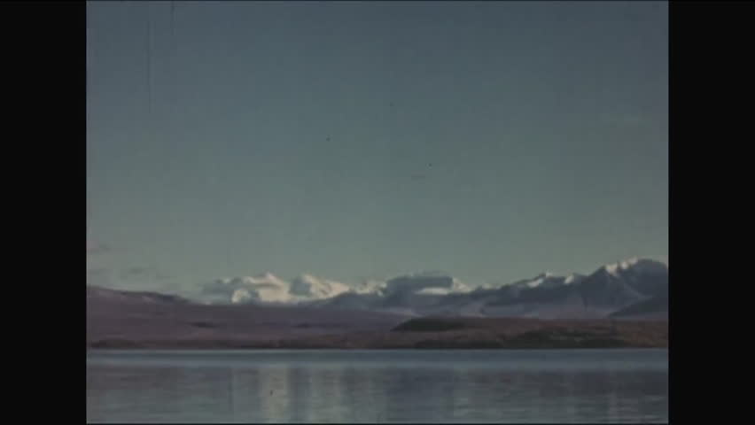 CIRCA - 1952 - Mountains, forests, tranquil lakes and small waterfalls are shown as part of the natural beauty of Alaska