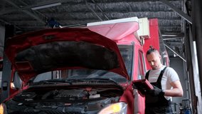 Mechanic repairing red truck engine in garage. Automotive vehicle maintenance - Powered by Shutterstock - Get 15% off with code: PIKWIZARD15