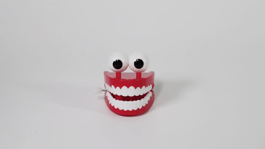 Hands interacting with a chattering teeth toy