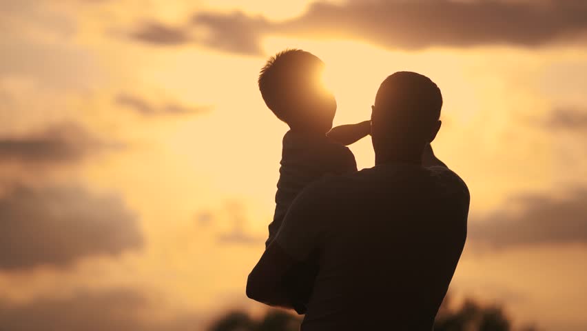 Father care is important kid toddler for healthy family. happy family kid concept. The silhouette of the father holding the son was visible in the sunshine dream. father and son in a forest park