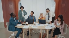 People working together in modern start up office. Multiethnic women and men planning and working on the company future projects. Business team sitting at the table and discussing new marketing ideas. - Powered by Shutterstock - Get 15% off with code: PIKWIZARD15