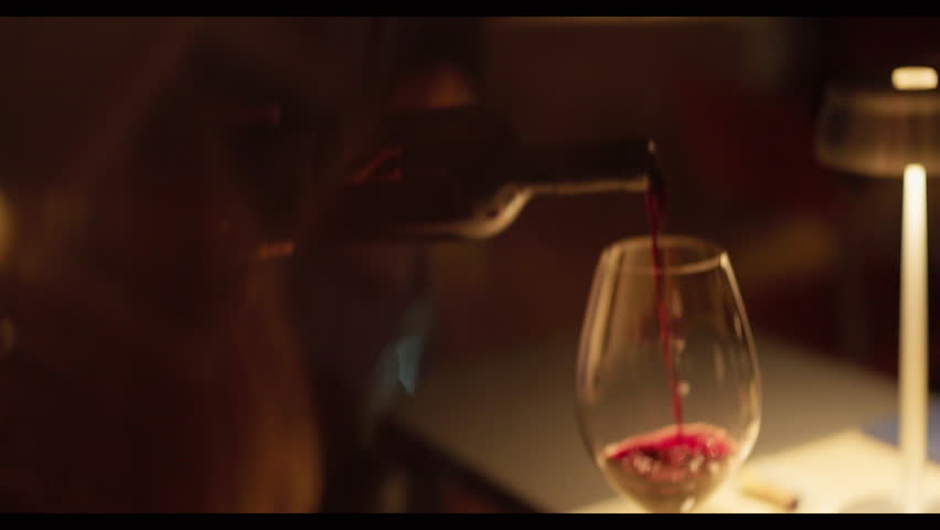 Waiter Pours Red Wine Into Glass For Guests.