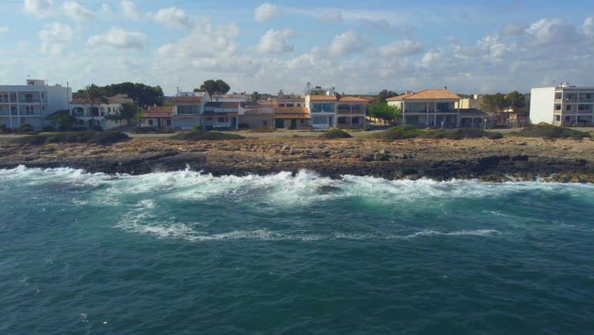 Aerial view of the coast of Majorca near Torrent de Cala Pi, flight over the sea during strong wave and rough sea.