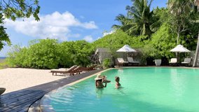 cute siblings school boy and teenage girl with served floating tray in swimming pool with drinks and snacks on tropical island resort in Maldives, cocktails and canapes in luxury hotel, travel concept - Powered by Shutterstock - Get 15% off with code: PIKWIZARD15