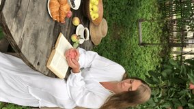 young woman model plus size in white dress sit at table with pet dog poodle, resting and drinking tea after harvesting autumn in back yard, fall and harvest, eco-friendly simple life, vertical video - Powered by Shutterstock - Get 15% off with code: PIKWIZARD15