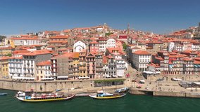 Portugal Porto aerial video city centre buildings bridges architecture rooftop 4k river boat ship waterfront bank people walking red yellow green blue awesome
