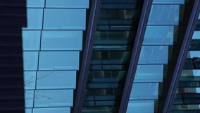 glass facade of a modern business center. Abstract modern business architecture. Blue sky and clouds reflected in structural modular glass wall. Vertical video. - Powered by Shutterstock - Get 15% off with code: PIKWIZARD15