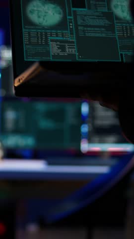 Vertical video Hacker arriving in secret base with laptop, ready to start programming viruses. Scammer in criminal den opening notebook to exploit network servers and bypass security measures, camera