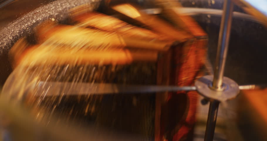 The beekeeper puts frames with honeycombs into the honey production machine