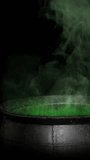 Vertical Witch Cauldron Smoking Green 4K Loop features a metal cauldron with green glowing smoke rising-up against a black background in a vertical ratio loop. - Powered by Shutterstock - Get 15% off with code: PIKWIZARD15