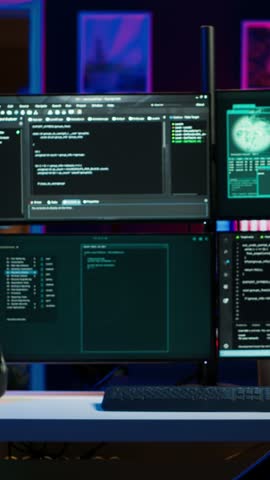 Vertical video Hacker arriving in underground HQ, ready to start coding malware designed to exploit network backdoors and bypass security measures such as logins and password protections, camera A