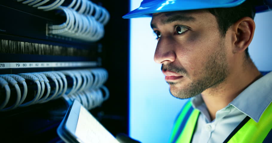 Data center, engineer and man with computer server for programming, coding and information technology. Cybersecurity, IT and technician with tablet for inspection, maintenance and software backup