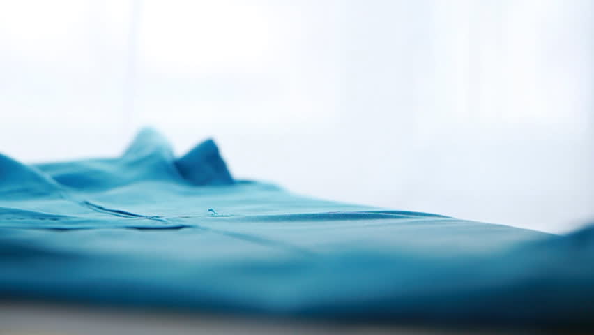 a man irons his medical form in slow motion 