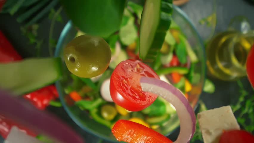 Super Slow Motion Shot of Fresh Salad Ingredients Following by Camera Falling into Bowl at 1000fps.