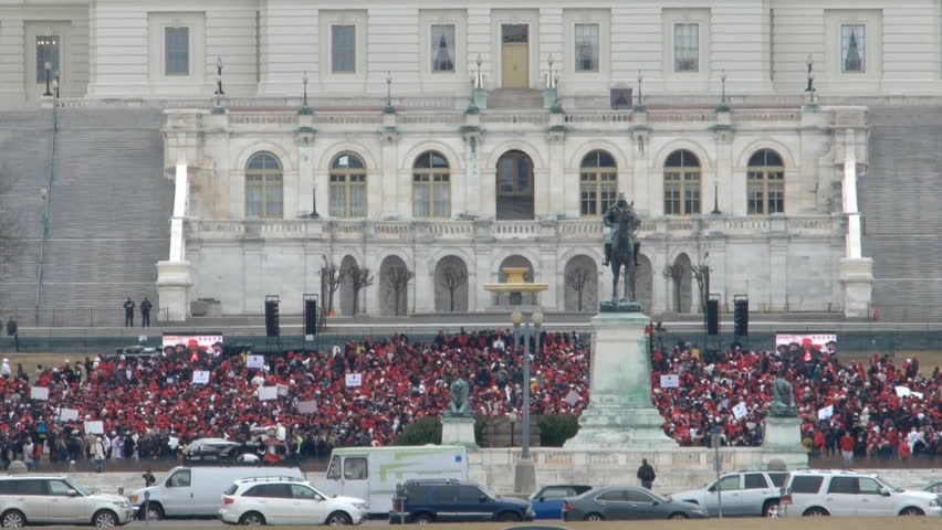 WASHINGTON DC - MARCH 3: Participants in the 100th anniversary of Washington’s Women’s Suffrage Parade rally at steps of the US Capitol March 3, 2013 in Washington DC, USA