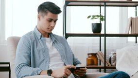 Interesting content. Emotional guy watching adult videos on mobile phone at home - Powered by Shutterstock - Get 15% off with code: PIKWIZARD15