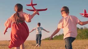 Children play with toy plane. Slow motion. Teenager dreams of flying, becoming pilot. Happy children run with toy plane across field at sunset. Boy, girl wants to become pilot, an astronaut. Children - Powered by Shutterstock - Get 15% off with code: PIKWIZARD15