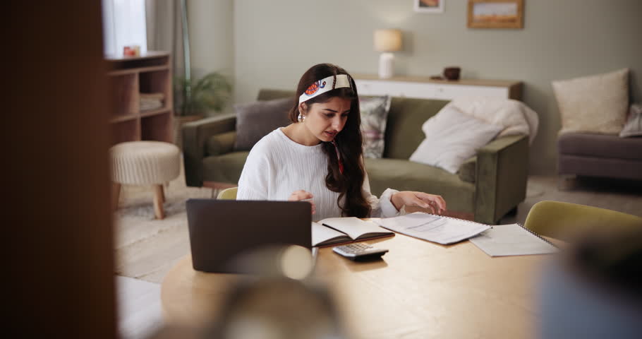 Woman, laptop and doubt for paperwork in home, budget and accountant for audit information. Female person, online tax website and confused for documents, plan and mistake or fail on finance report