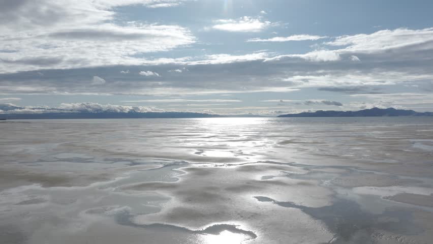 Aerial orbit over Great Salt Lake, Utah on a sunny spring day.