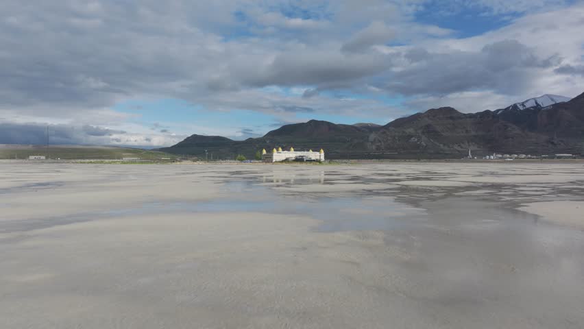 Aerial push in of the Great Saltair venue on the shore of the Great Salt Lake, Utah on a sunny spring day.