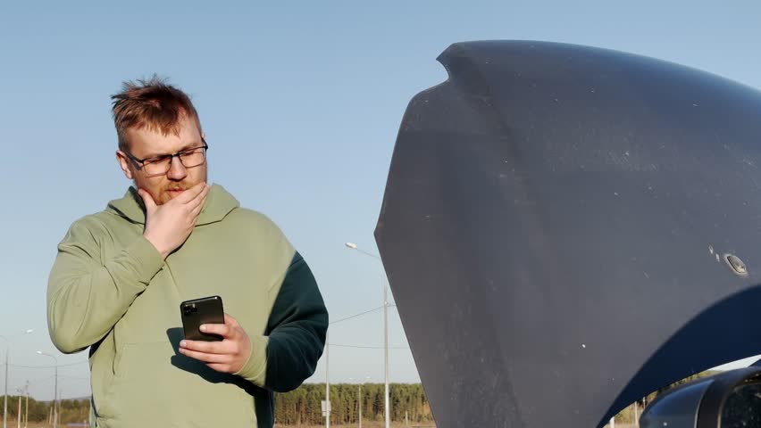car and man. car with an open hood. slow motion video. High-quality shooting in 4K