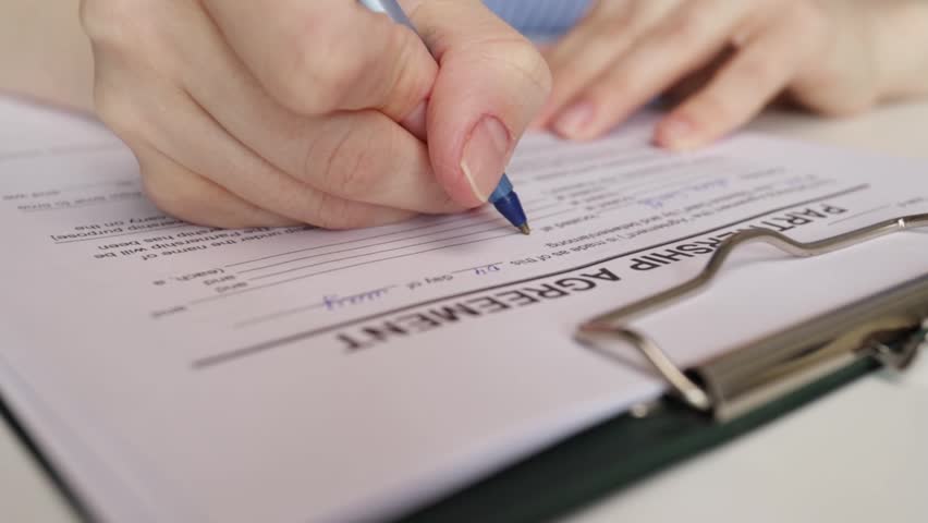 Partnership agreement, hand fills out a document, finance deal, corporate signing, successful partnership.