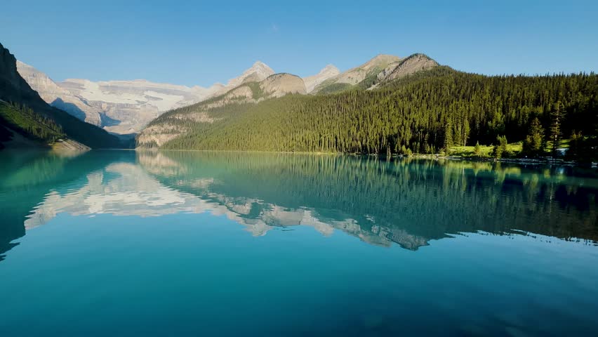 Lake Louise is located in the Rocky Mountains of the province of Alberta, Canada. Enveloped by lush forests and dominated by the Victoria Glacier. Excursions. Canoe. Crystal clear lake. Sunrise.