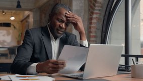 African American entrepreneur typing laptop computer check data in papers dissatisfied problem mistake report bad result sad stress business man office businessman male guy research analyse documents - Powered by Shutterstock - Get 15% off with code: PIKWIZARD15