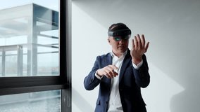 A businessman in a suit uses a VR headset, showcasing augmented reality technology in a sleek, modern office. - Powered by Shutterstock - Get 15% off with code: PIKWIZARD15