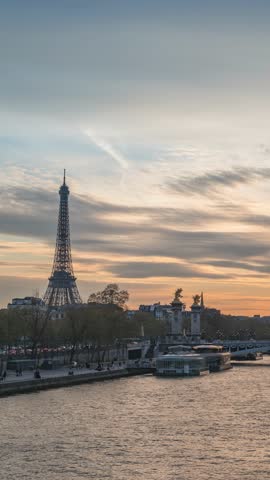 Paris France time lapse sunset city skyline at Seine River with Pont Alexandre III bridge and Eiffel Tower (Vertical)