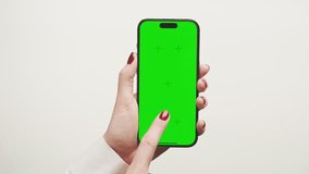 Hand Showing Smartphone with Green Screen on White - Powered by Shutterstock - Get 15% off with code: PIKWIZARD15