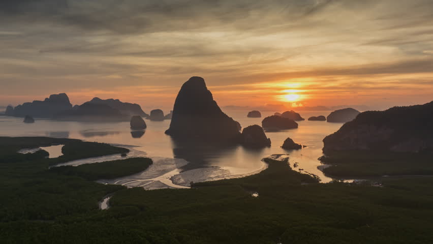 Hyperlapse aerial view drone flying over mangrove forest and mountain peak at sunrise, Phang nga bay, Thailand

