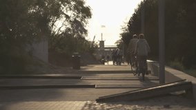 People cycling and walking along Pärnu Beach path at sunset - Powered by Shutterstock - Get 15% off with code: PIKWIZARD15