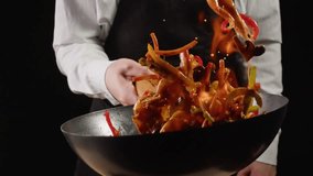 Chef cooking shrimps with mix vegetables on wok frying pan close-up. Prawns on fire throwing them on pan. Restaurant Food concept. Sea food. - Powered by Shutterstock - Get 15% off with code: PIKWIZARD15