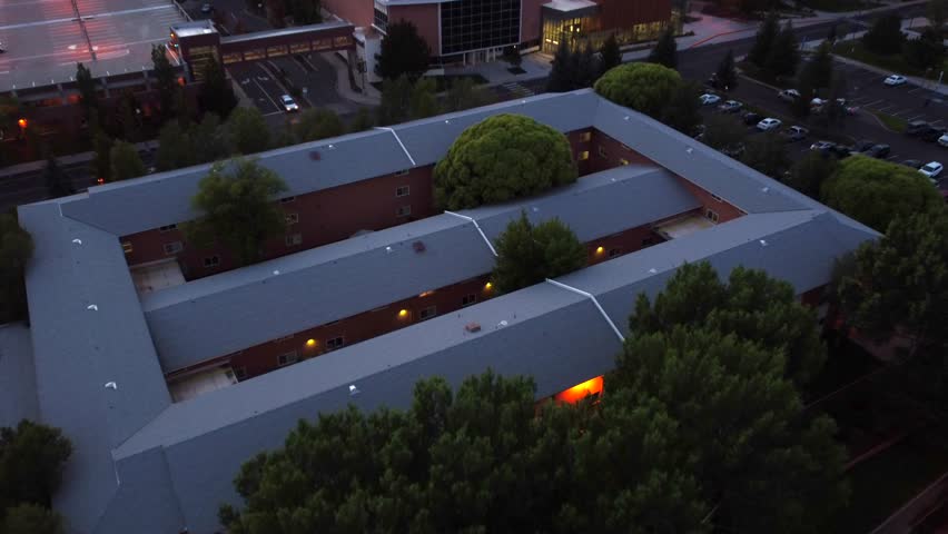 Tree Overtaking Dormitory on University Campus