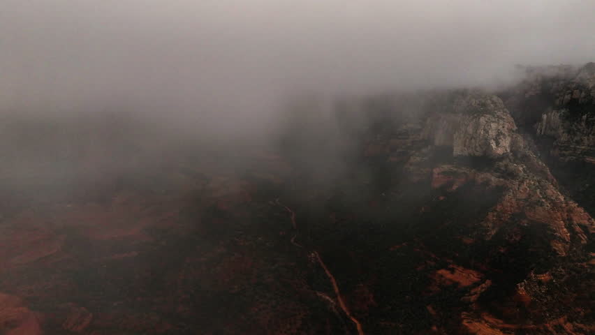 Fog Clouds Covering Red Rock Formations In Sedona, Arizona. aerial, timelapse