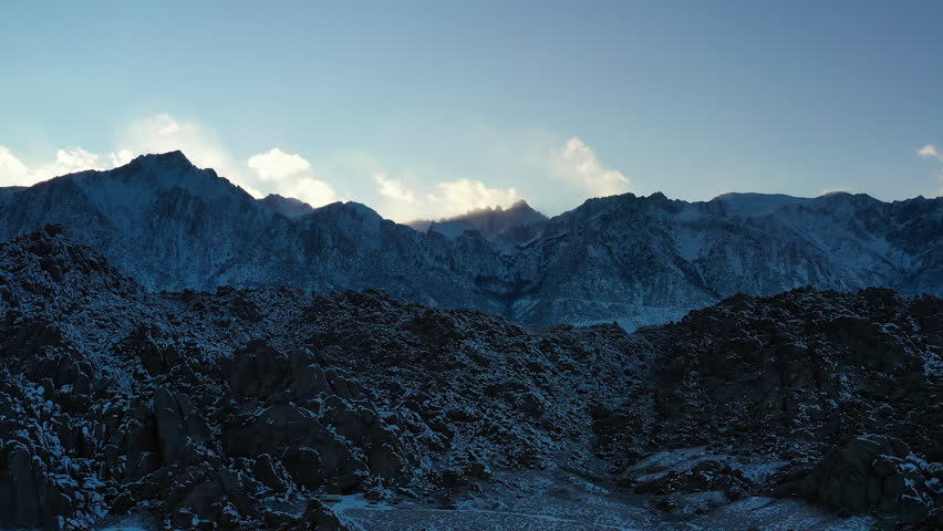 Rocky Mountains And Hills With Snow In Sierra Nevada Range In Inyo County, California. drone pullback shot