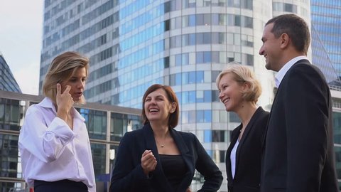 Financial team employees speaking with boss in La Defense Paris. Concept of decision making and business meeting. Responsible people planning work outside.