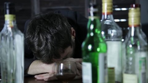 lonely man pour sadness an alcohol in the bar. social issue alcoholism