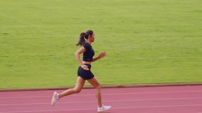 Asian young sportswoman sprint on a running track outdoors on stadium. Attractive strong athlete girl runner exercise and practicing workout speed running marathon on the race for olympics competition - Powered by Shutterstock - Get 15% off with code: PIKWIZARD15