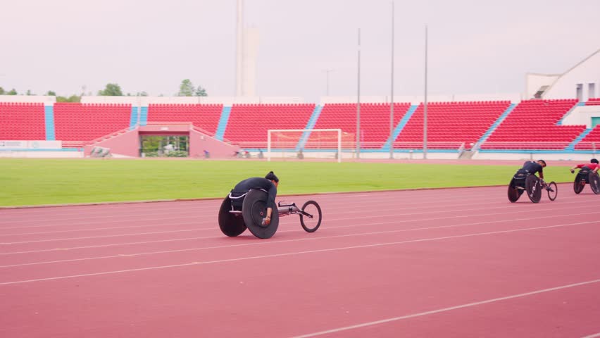 Professional man para-athletes disabled practice handcycling in stadium. Attractive amputee male runner exercise and practicing workout for Paralympics competition regardless of physical limitations.