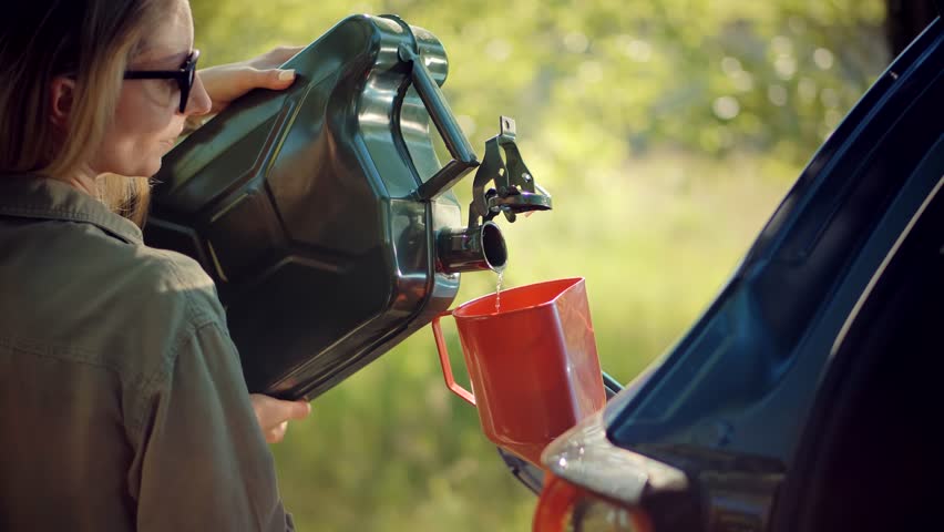 Filling Bio Diesel Into Gas Tank Canister. Refilling Gasoline Fuel Tank Car. Energy Petrol Crisis Price. Driver Opens Car Fuel Tank Filling Gasoline. Fill Petrol Benzine On Trip Canister Auto Journey