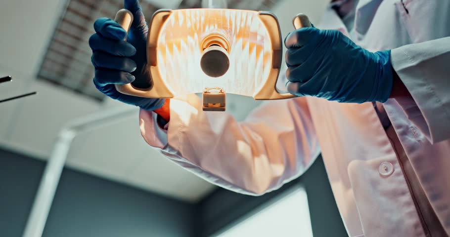 Dentist, light and pov with doctor in hospital for oral hygiene, service and medical consultation. Healthcare, dentistry and low angle with equipment at clinic for dental care, support or appointment