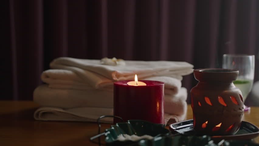 Burning candles, aroma lamp, bath towels and vitamin cocktail for relax at a spa wellness center. Burning candle light in bathroom near bathtub. Glass of champagne. Romantic evening background. - Powered by Shutterstock - Get 15% off with code: PIKWIZARD15