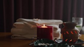 Burning candles, aroma lamp, bath towels and vitamin cocktail for relax at a spa wellness center. Burning candle light in bathroom near bathtub. Glass of champagne. Romantic evening background. - Powered by Shutterstock - Get 15% off with code: PIKWIZARD15