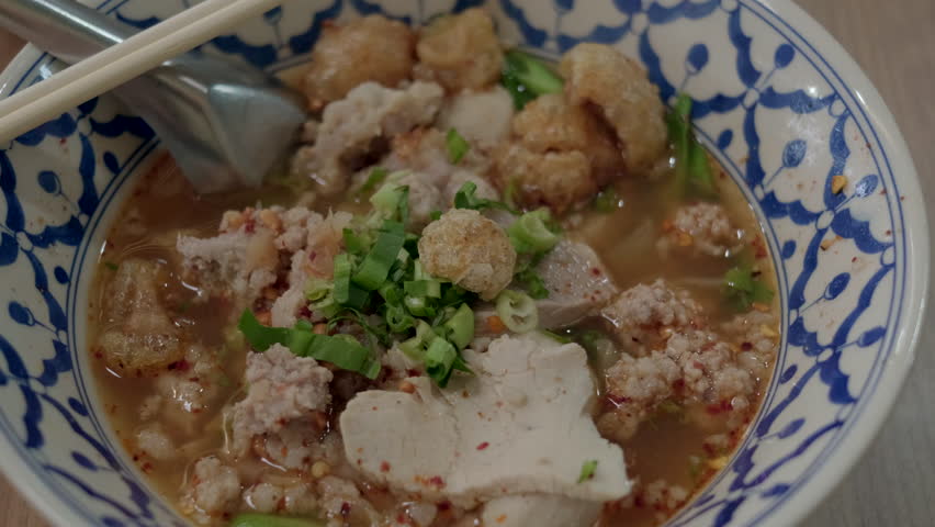 noodles with pork and meatballs in spicy soup or Tom yum noodles in Asian style