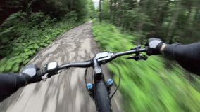 Point of view. Couple of cyclist riding electric mountain bikes in the forest. Concept of adventure, leisure time outdoors. - Powered by Shutterstock - Get 15% off with code: PIKWIZARD15