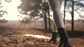 tourist girl walks through the forest. tourist recreation concept. female legs in black boots walk through a bright spring forest with glare of the sun close-up lifestyle. tourist - Powered by Shutterstock - Get 15% off with code: PIKWIZARD15