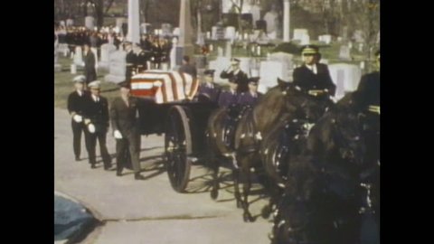 1960s: Soldiers and horses lead military funeral procession through cemetery. Spectators watch procession.
